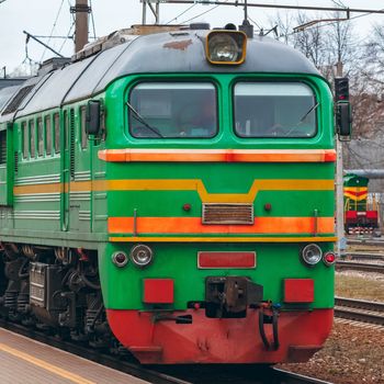 Green diesel cargo locomotive. Freight train in action