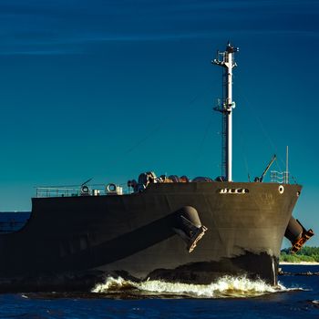 Black bulk carrier moving at evening to Baltic sea