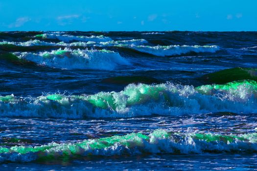 Summer ocean beach with green waves at sunny day