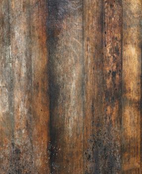 Vintage brown barrel wooden planks background texture with scratches and black stains over wood grain of old aged oak barrel bottom, close up