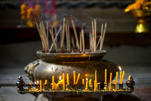 light candle burning for worship the buddha in the temple