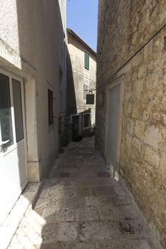 Narrow empty street of medieval town on a sunny dag