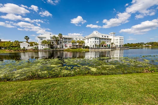 A hotel building with a lake in front