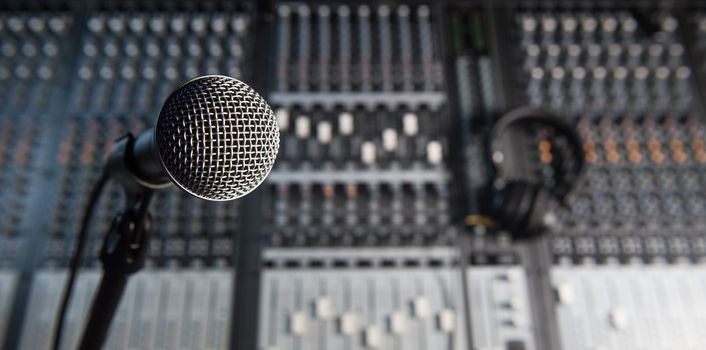 Microphone and Headphones on dirty sound mixer panel, France