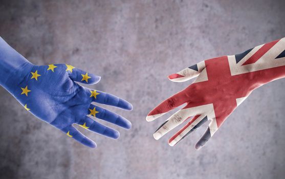 Hands painted with UK and European flag reaching out for a handshake