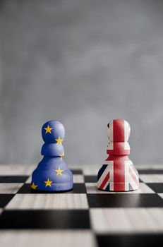 Two pawns with UK and European flags on a chessboard
