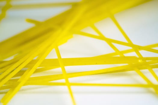 raw spaghetti pasta on a white background. Macro shot