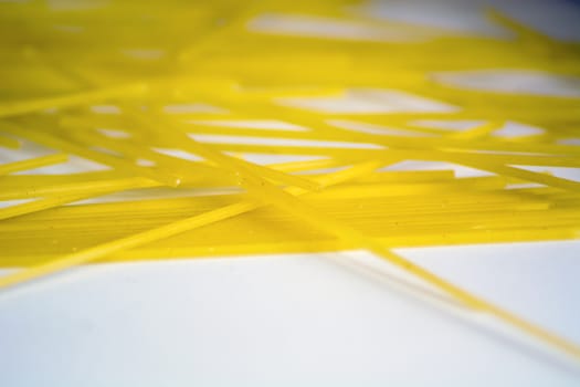 raw spaghetti pasta on a white background. Macro shot