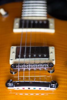 Close up of an electric guitar bridge in vintage effect