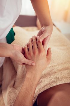 Man enjoying during a relax massage at the spa. 