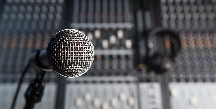 Microphone and Headphones on dirty sound mixer panel, France