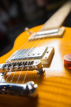 Close up of an electric guitar bridge in vintage effect