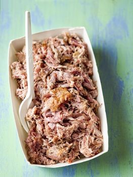 close up of rustic american pulled pork in paper tray