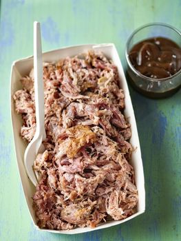 close up of rustic american pulled pork in paper tray