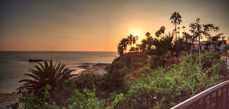 Sunset over the ocean through a neutral density filter at Main Beach in Laguna Beach, California, USA