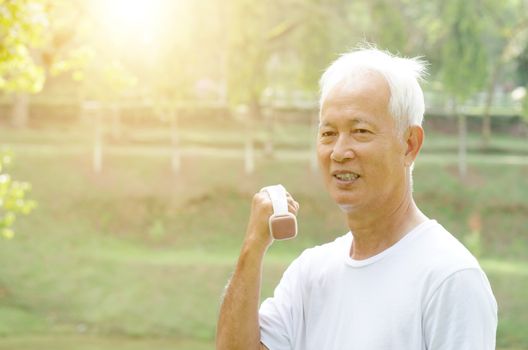 Portrait of healthy gray hair Asian old people exercising at outdoor park in morning.