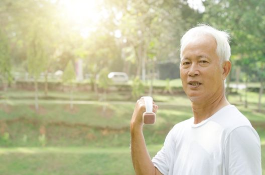 Portrait of active healthy grey hair Asian old man workout at outdoor park in morning.