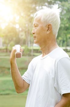 Portrait of active healthy white hair Asian old man workout at outdoor park in morning.