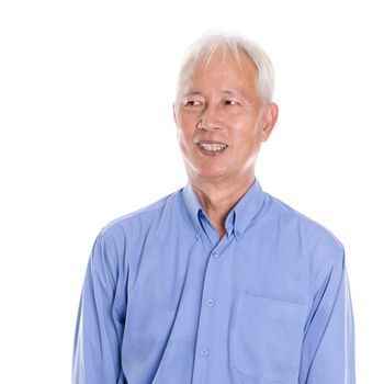 Portrait of old Asian senior man smiling and looking at side, standing isolated on white background.