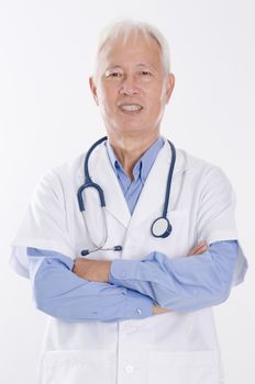 Portrait of Asian medical doctor arms crossed smiling, standing isolated on white background.