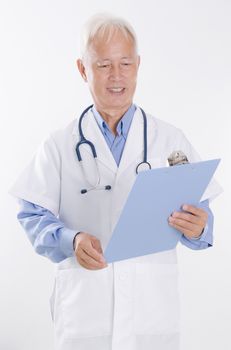 Portrait of Asian medical doctor reading on health report, standing isolated on white background.