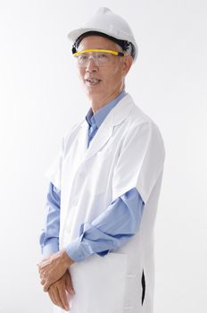 Portrait of old Asian senior engineer with hard helmet and uniform, standing isolated on white background.