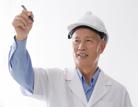 Portrait of Asian engineer with hard hat, hand writing on blank space, standing isolated on white background.