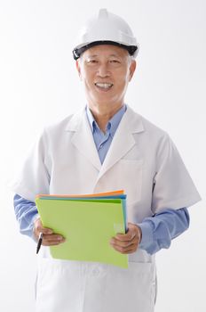 Portrait of old Asian engineer in uniform with hard hat, standing isolated on white background.
