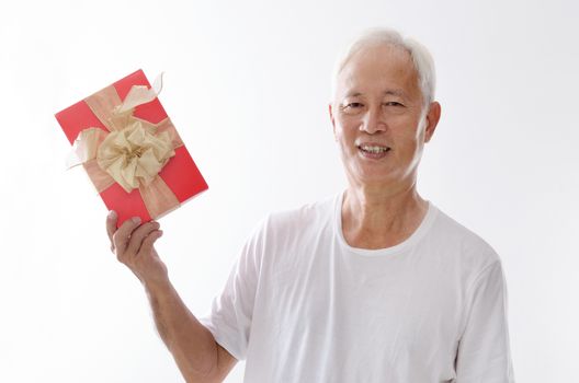 Portrait of old Asian man hand holding a gift box, isolated on white background.