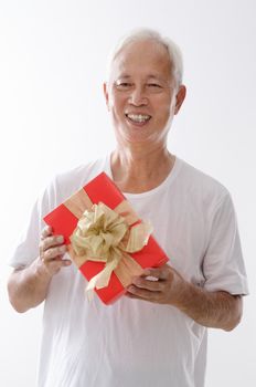 Portrait of old Asian father hand holding a gift box, isolated on white background.