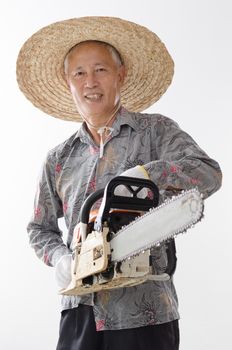 Portrait of old Asian man hand holding chainsaw standing isolated on white background.