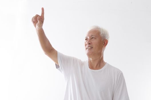 Portrait of old Asian man hand pointing on blank space, isolated on white background.