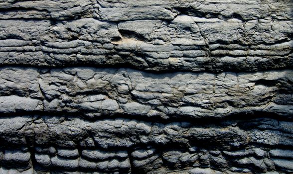 Background of Textured Shale Stone with Weathered Wave Shape closeup Outdoors
