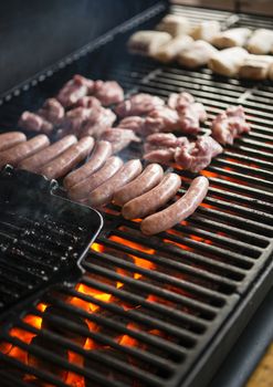 Italian barbecue with different meat parts to cook.