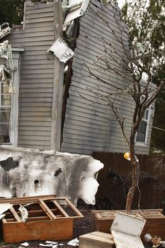 Wooden house damaged by disaster.