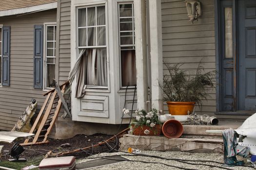 Wooden house damaged by disaster.