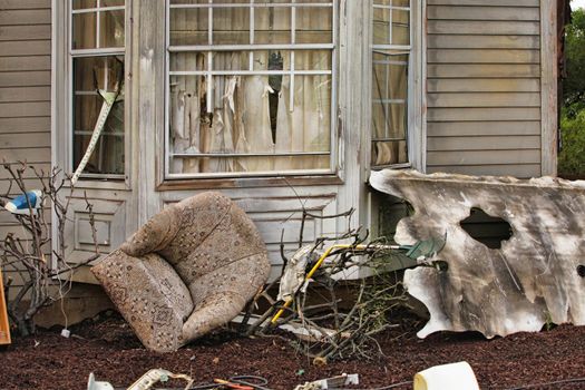 Wooden house damaged by disaster.