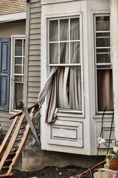 Wooden house damaged by disaster.