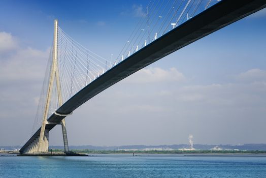 pillar of the bridge "Pont de Normandie" reflected in the Seine river at Le Havre, France