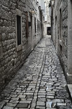 a medieval cobbled street in the town of Trogir in Croatia