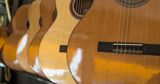 Many Classical Guitars Hanging on Wall in the Shop, France