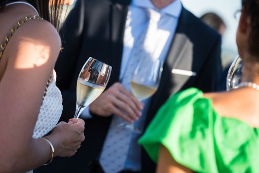 Happy friends with glasses of champagne, luxury diner
