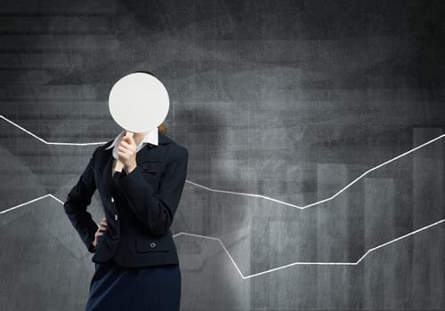 Businesswoman and graphs at background hiding her face behind mask