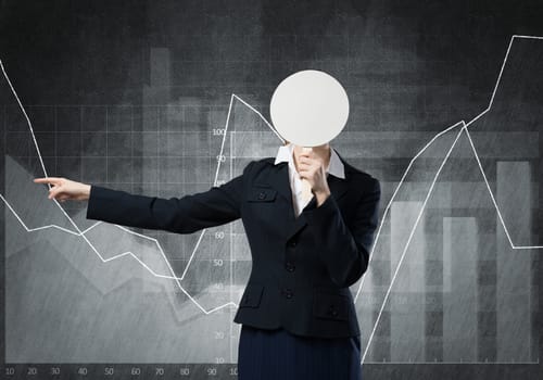 Businesswoman and graphs at background hiding her face behind mask