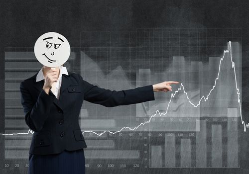 Businesswoman and graphs at background hiding her face behind mask