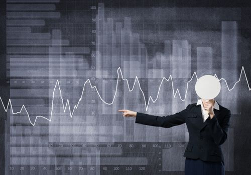 Businesswoman and graphs at background hiding her face behind mask