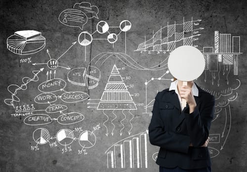 Businesswoman and graphs at background hiding her face behind mask