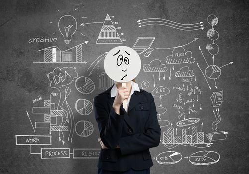 Businesswoman and graphs at background hiding her face behind mask