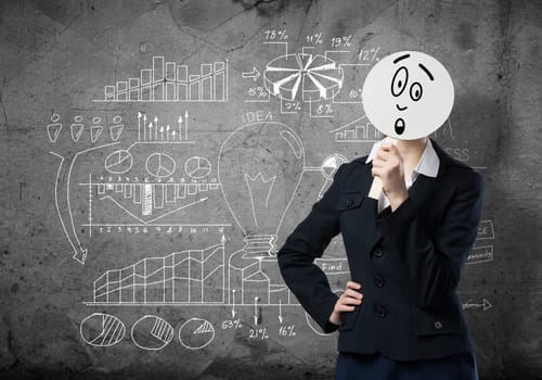 Businesswoman and graphs at background hiding her face behind mask