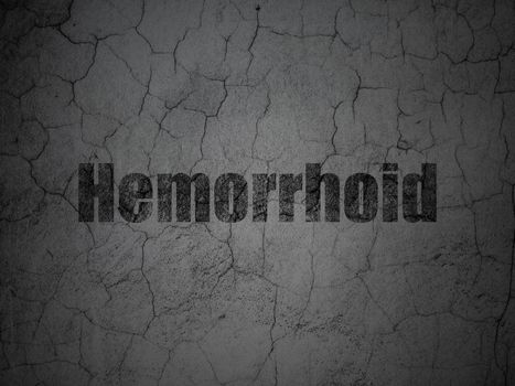 Medicine concept: Black Hemorrhoid on grunge textured concrete wall background